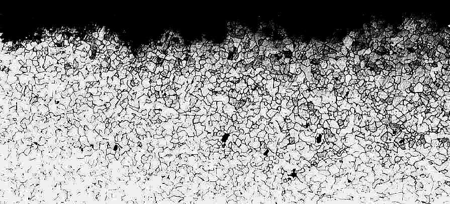 eroded edge in the central area (magnification: x 50; optical microscopy)